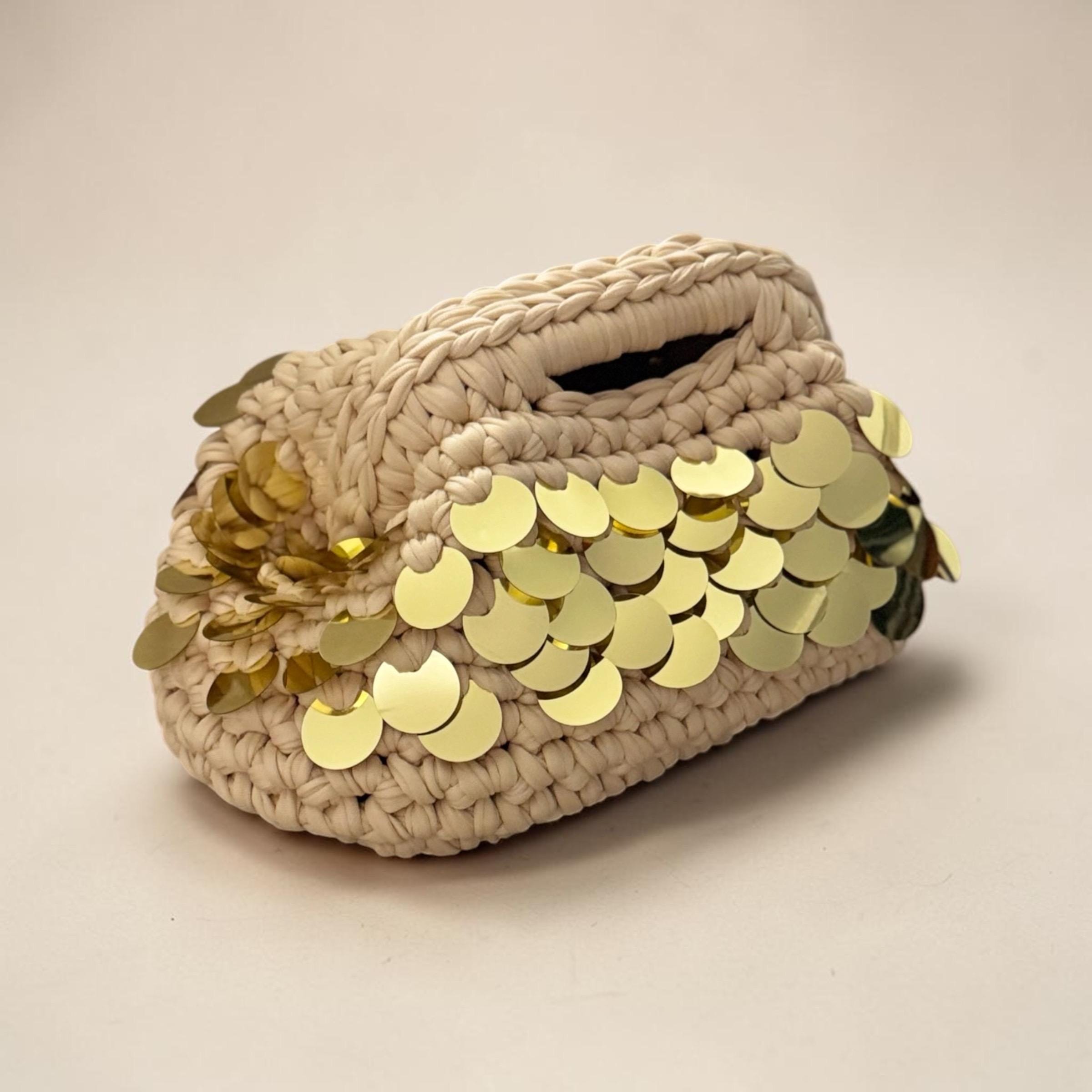 Beige crochet clutch with gold sequin accents and fermoir clasp