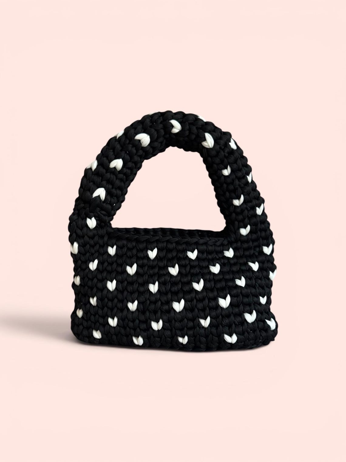 Black crochet mini handbag with white heart pattern