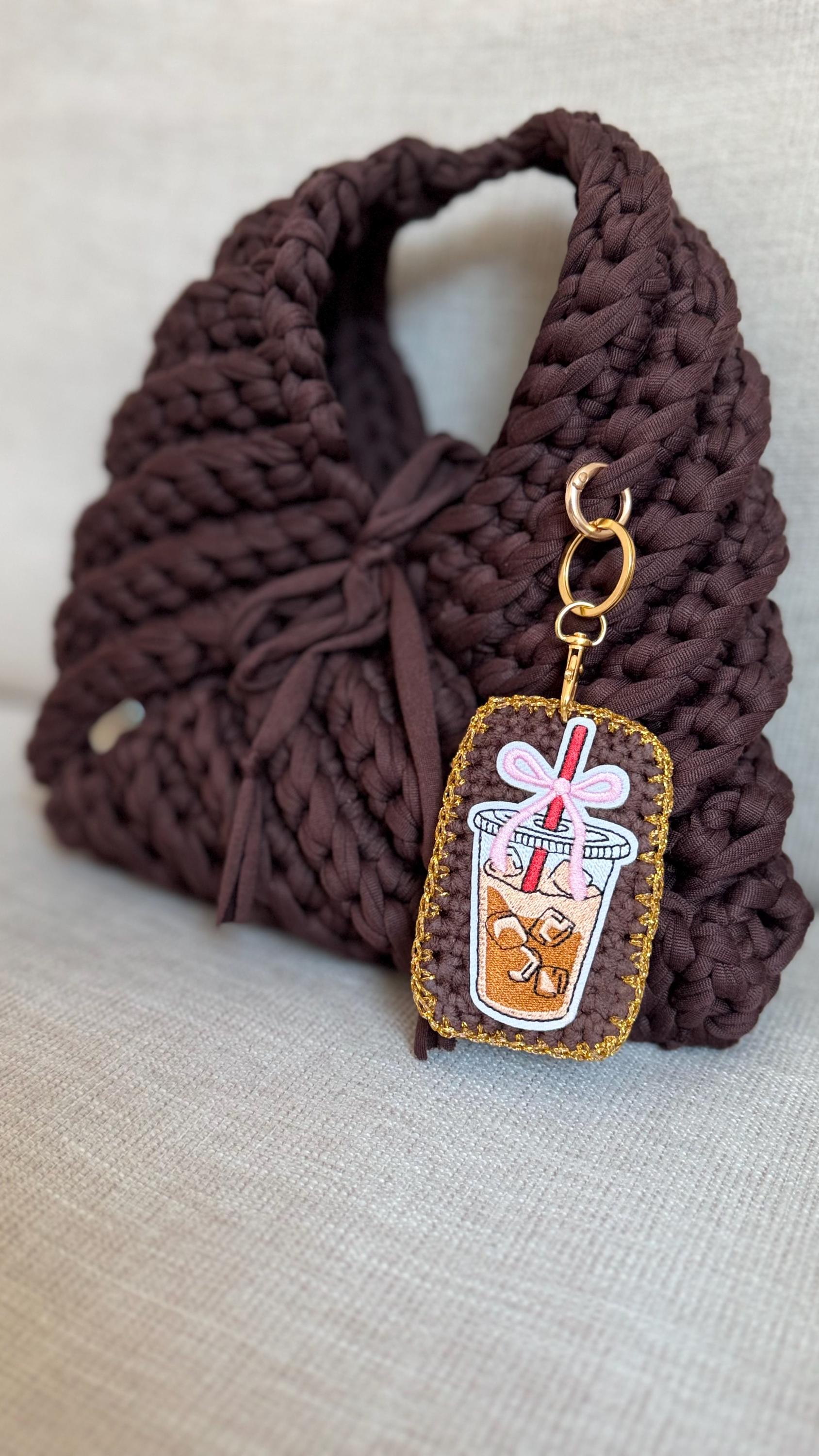 Brown Triangular Handbag with Iced Coffee Charm, side view