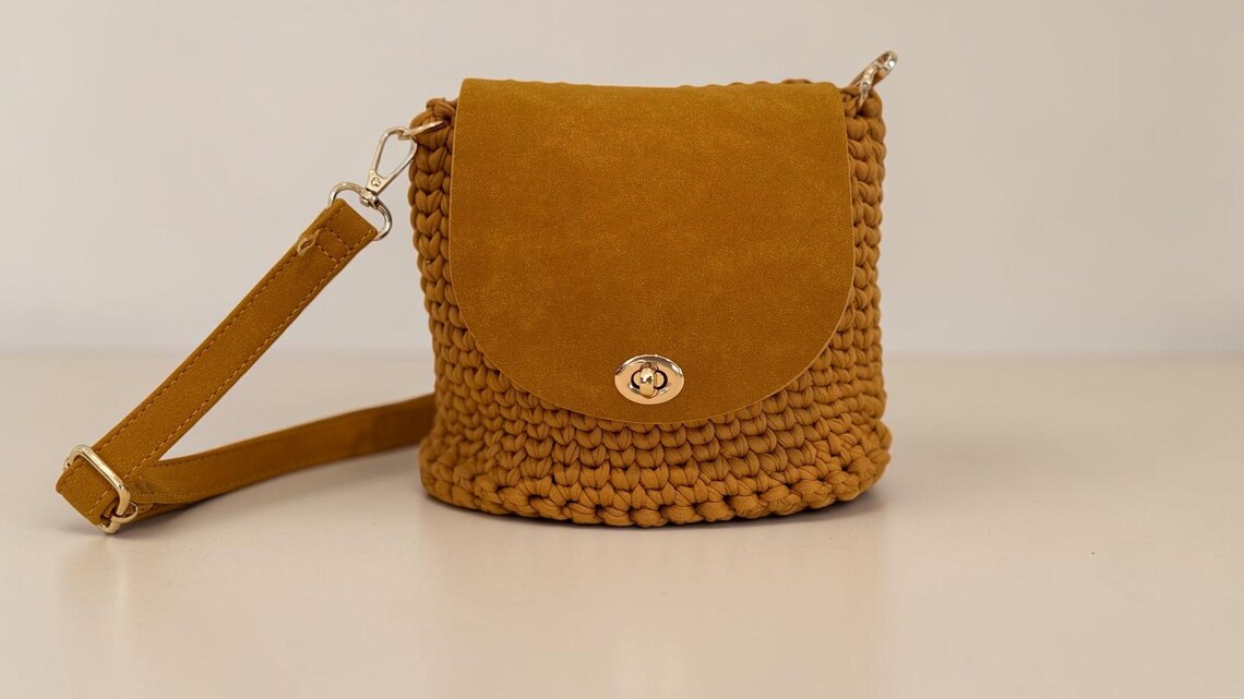 Camel crochet crossbody bag with faux suede flap and gold details