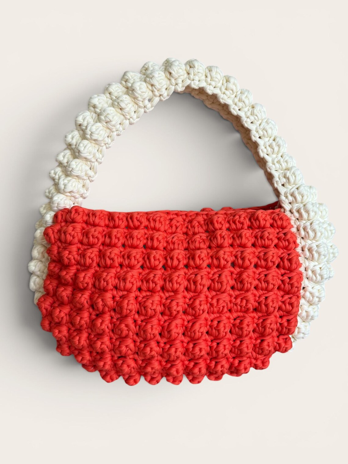 Coral bobble-stitch crochet handbag with cream handle