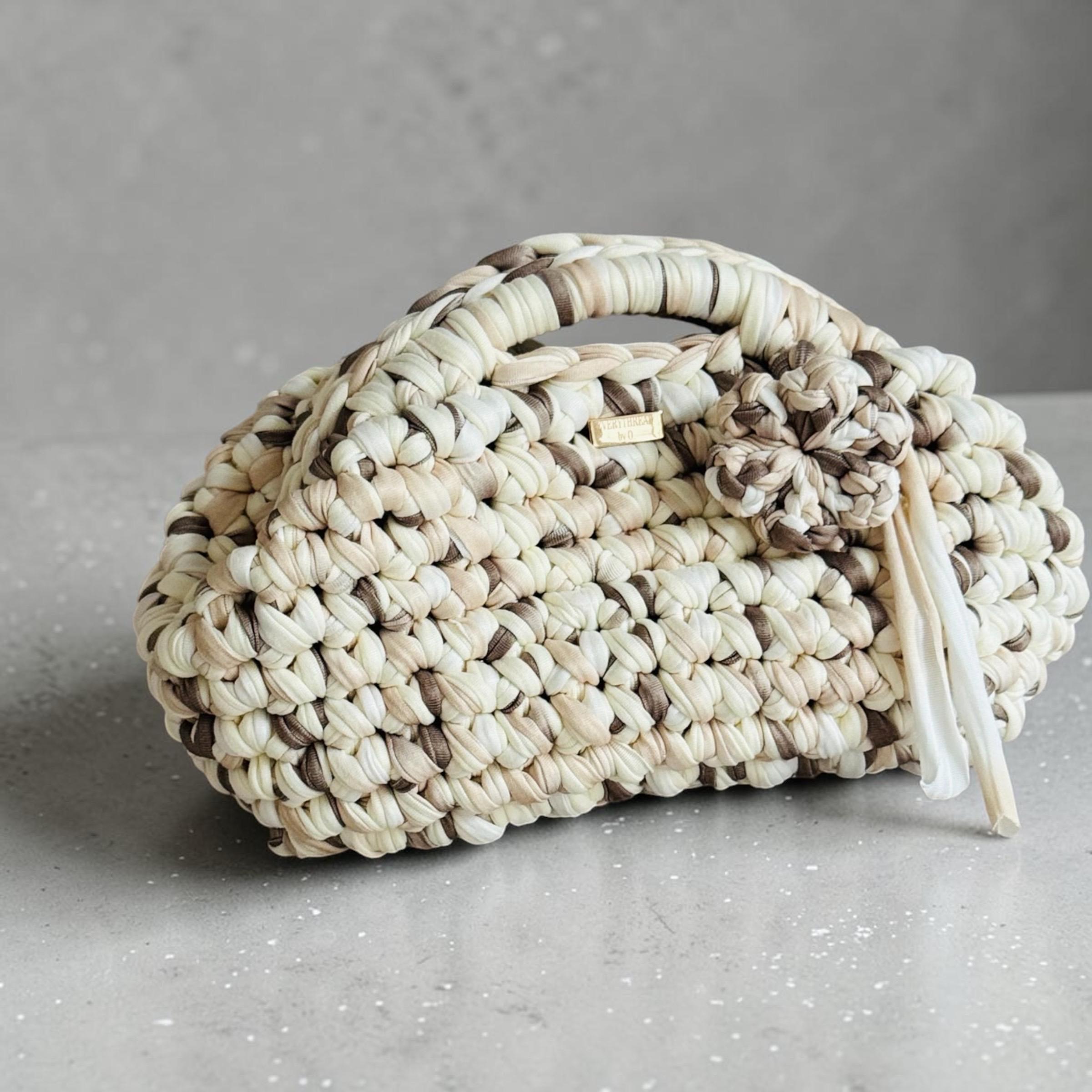Cream and taupe crochet clutch with flower charm and fermoir clasp