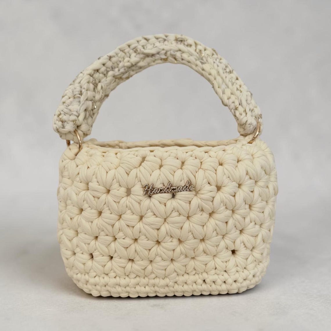 Handmade floral textured cream crochet handbag with gold thread handle