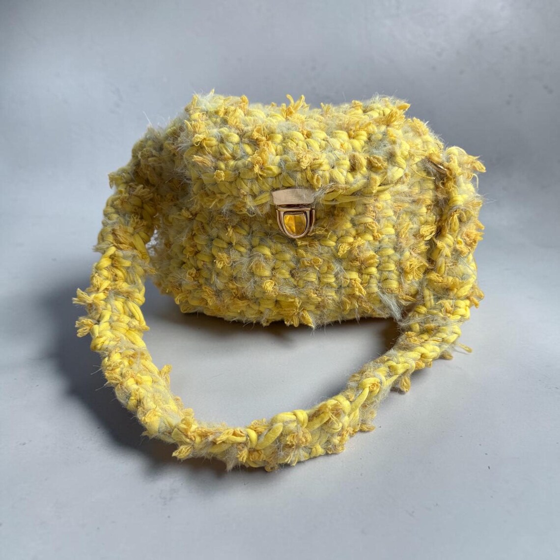 Handmade fluffy yellow crochet mini bag with flower texture and gold clasp