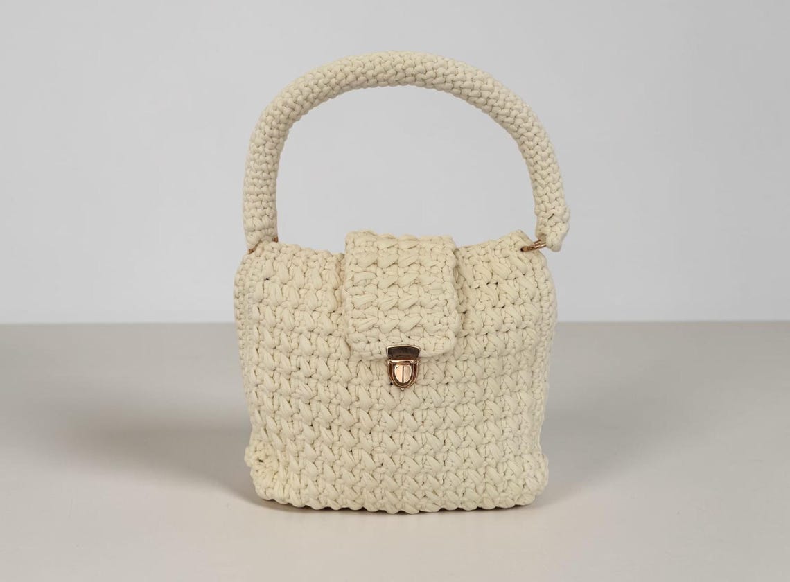 Large cream chunky crochet handbag with flap closure and gold clasp