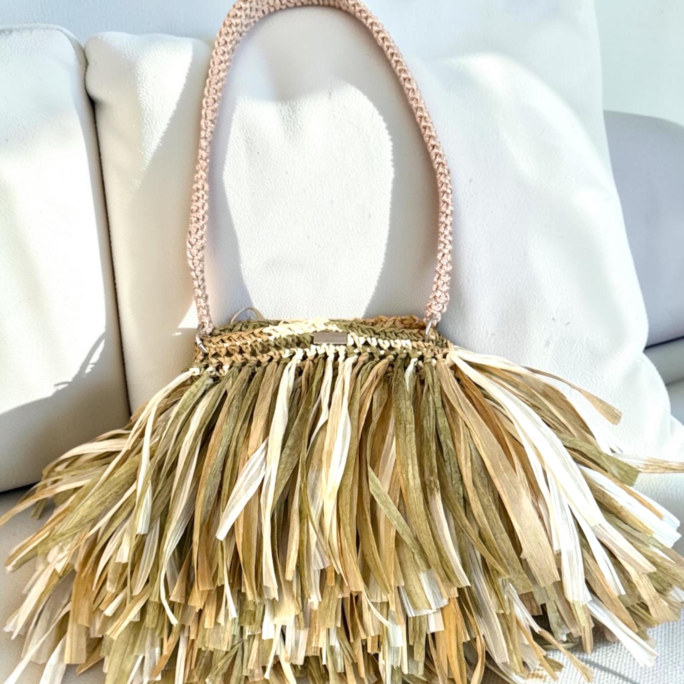 Handmade voluminous raffia shoulder bag with layers of long, flowing natural fringe