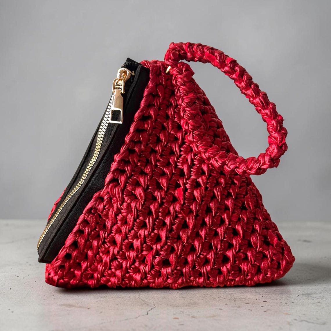 Red metallic crochet pyramid-shaped bag with top handle