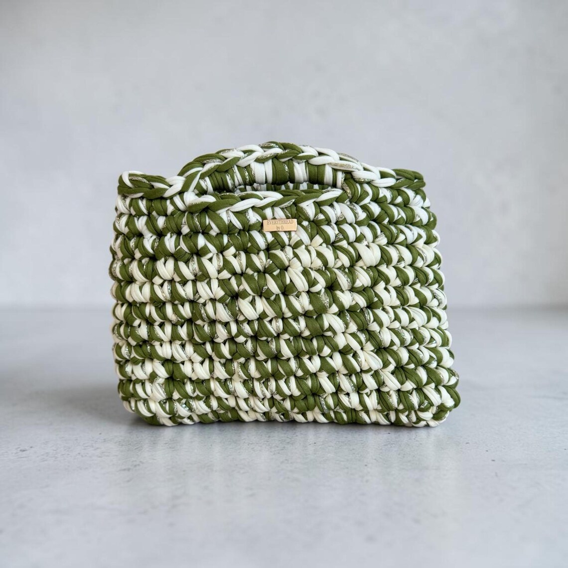 Olive green and cream crochet top handle bag with sparkly thread detail
