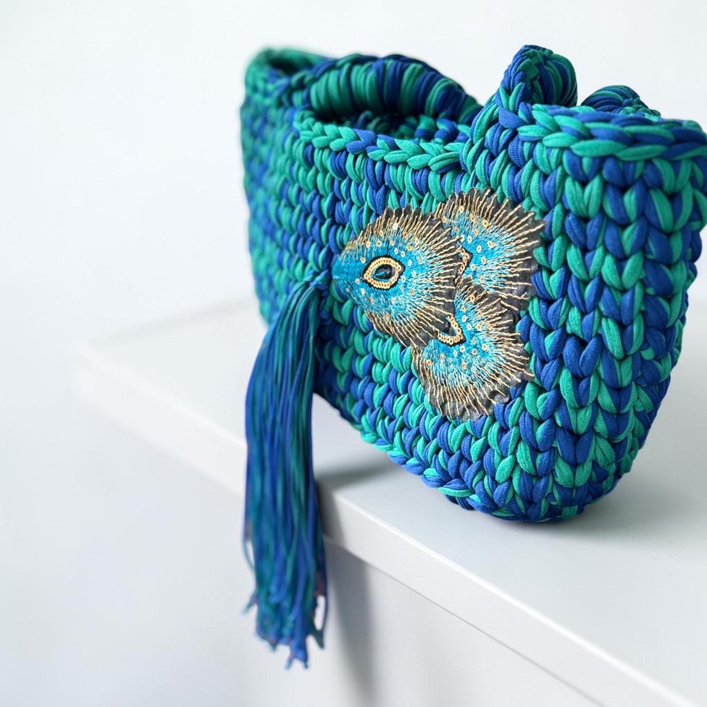 Blue and turquoise crochet shoulder bag with peacock appliqué and long tassel