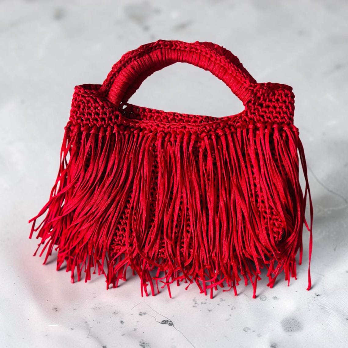 Red crochet mini bag with flowing fringe detail