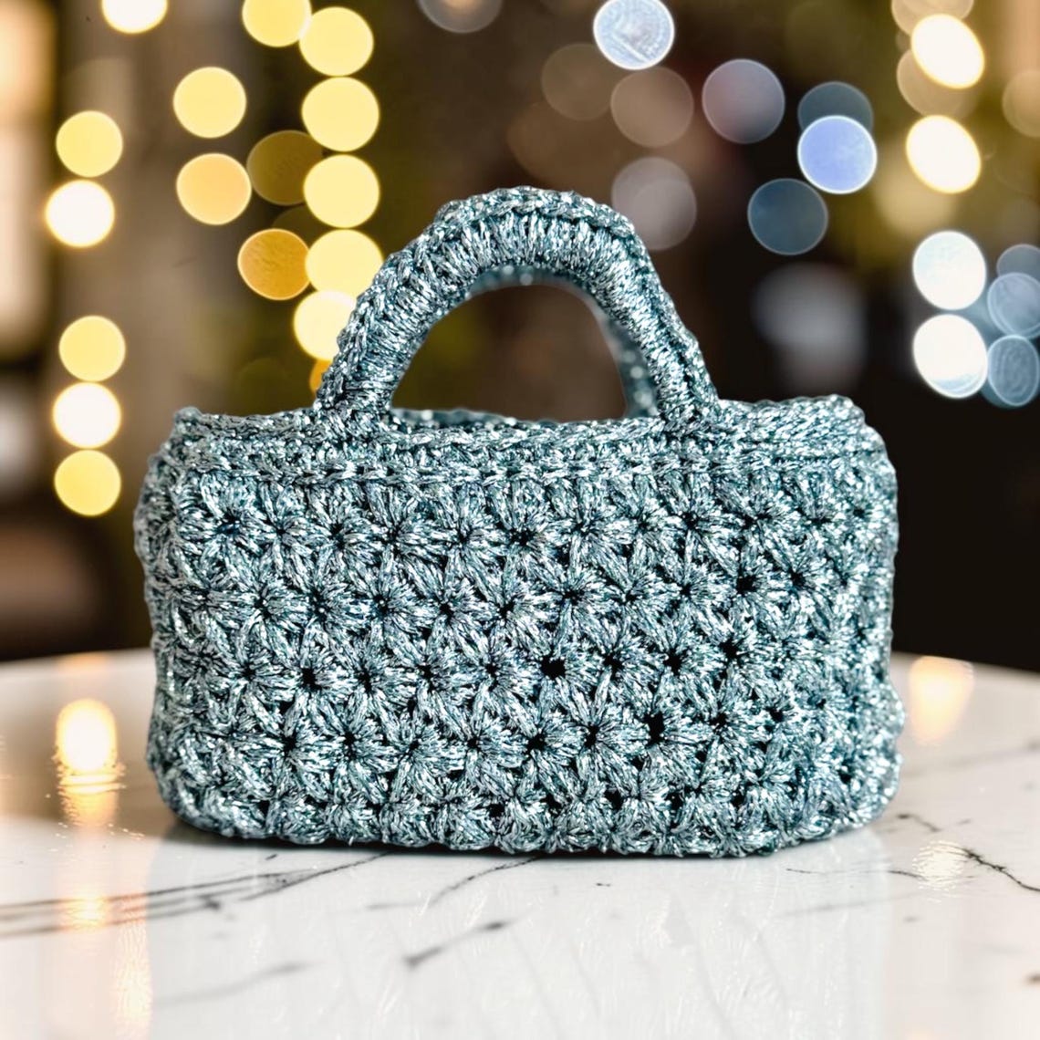 Silver metallic crochet mini handbag with flower stitch pattern