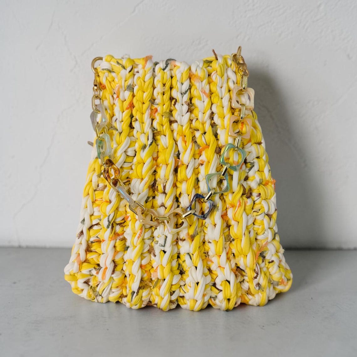 Yellow and white crochet handbag with colourful chain handle